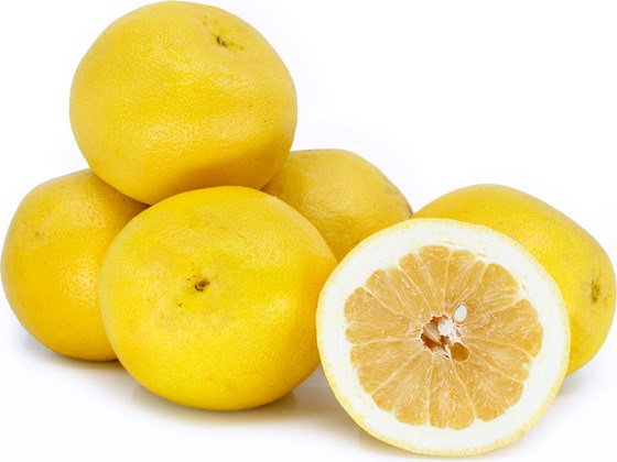 Sweet ripe grapefruits on white surface