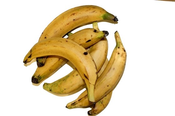 1/2 doz ripe plantains on white surface