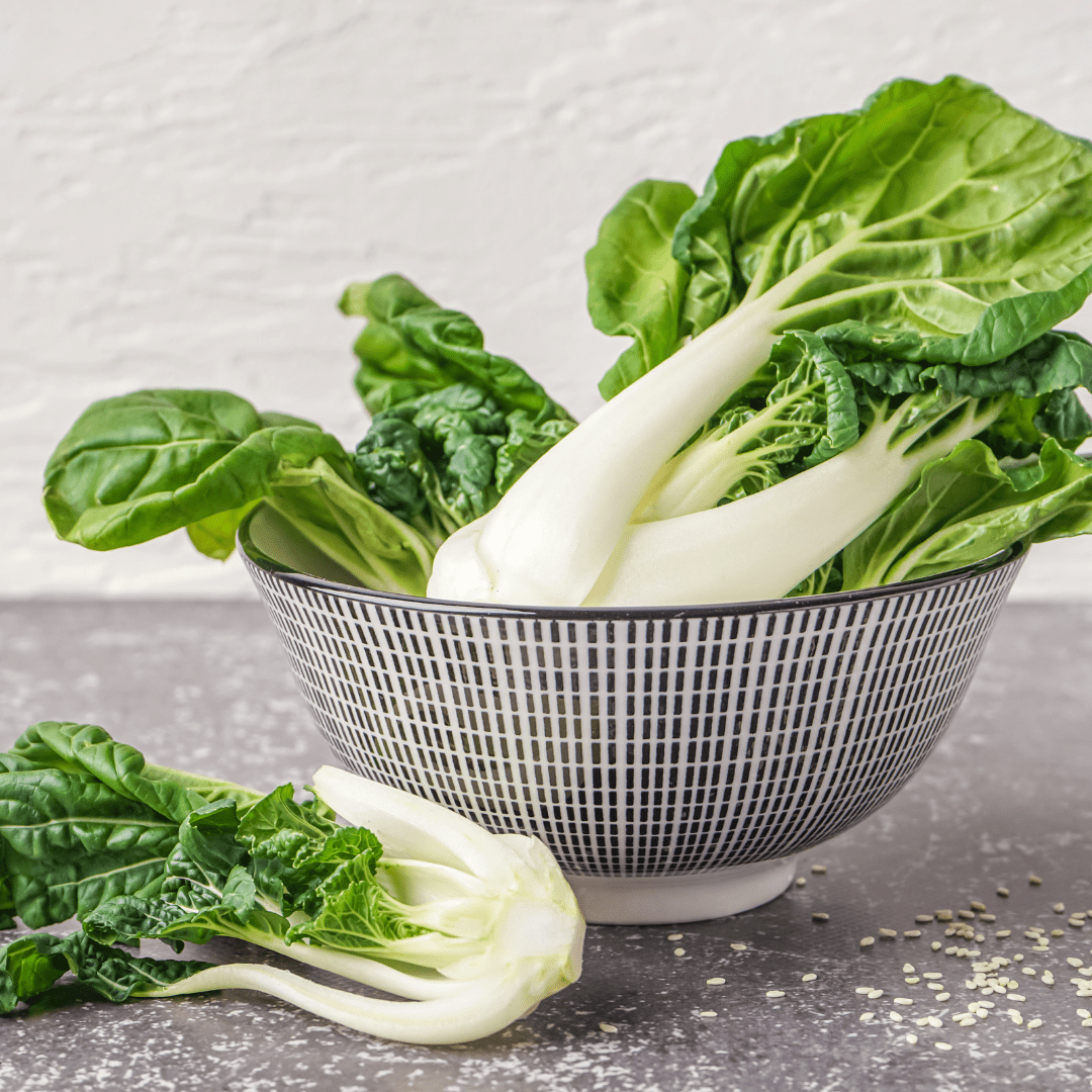 washed pak choi on table in a bowl