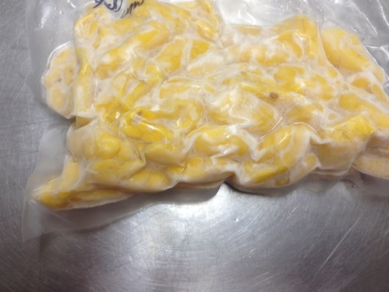 pre-cooked ackee in a vaccum bag on silver surface