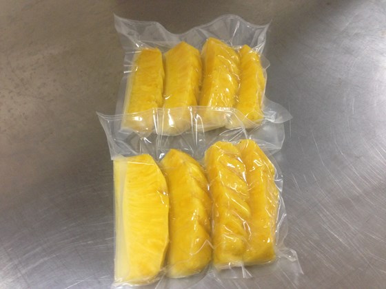 peeled, sliced pineapples packaged