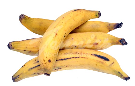 four ripe plantains on a white surface