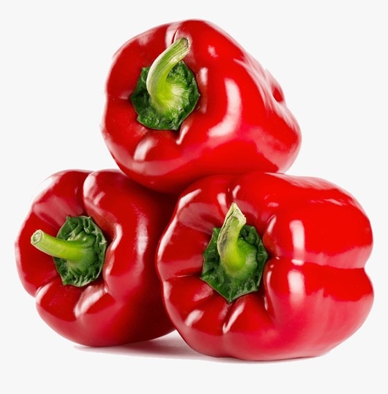 three red bell peppers on a white surface