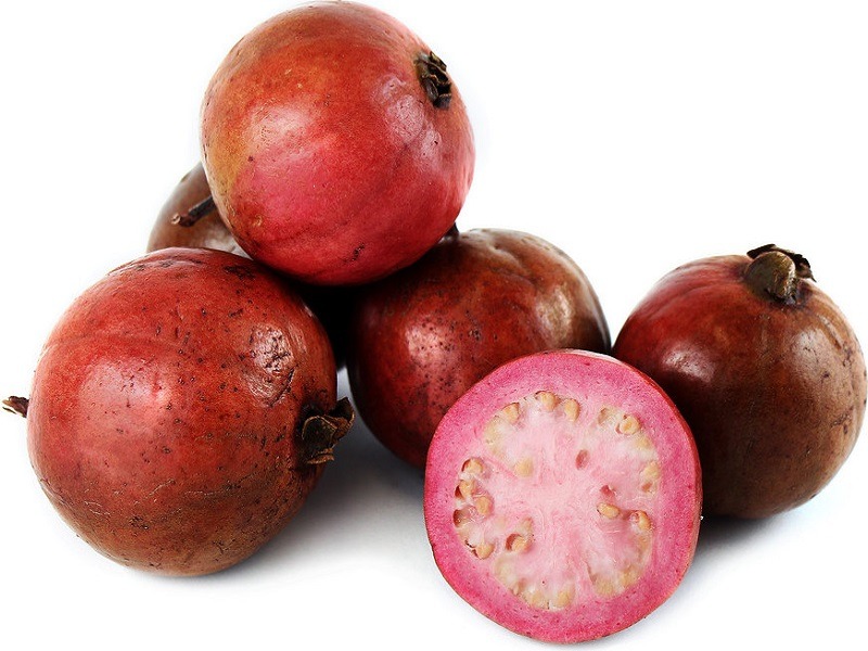Pomegranate fruit on a white surface