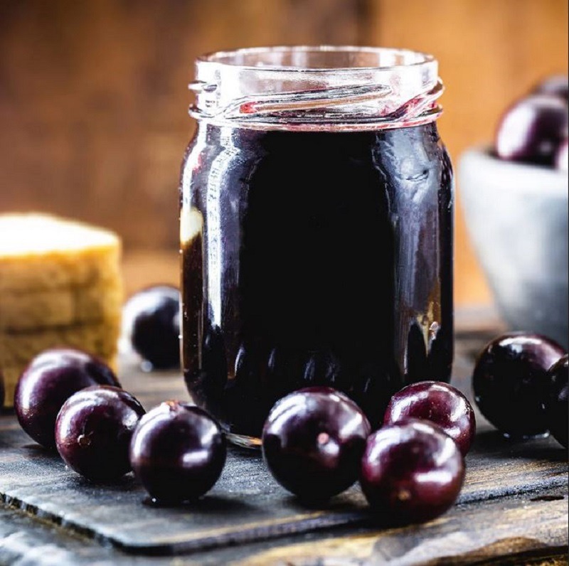 Purple Cherry Jam and cherries on a table